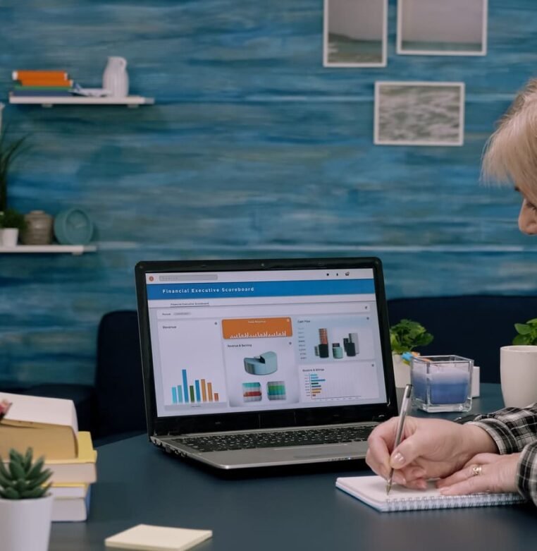 focused-senior-entrepreneur-checking-graphics-from-laptop-1-1